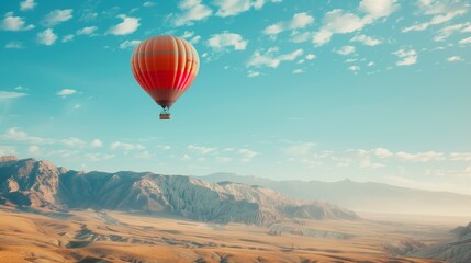Obraz premium Hot Air Balloon Floating in Clear Sky with Mountains