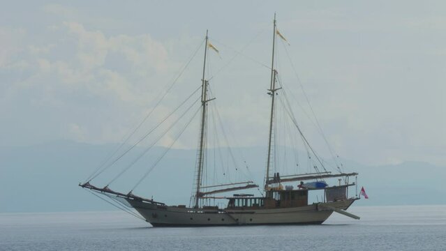 two-masted yacht anchored near Kri Island, Raja Ampat, Indonesia. Static shot.