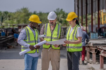 Engineer or foreman worker architecture  safety uniform survey at structure building site blueprint and document check detail and measure of common work is building architecture business concept.