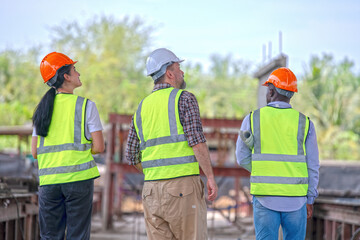 Engineer or foreman worker architecture  safety uniform survey at structure building site blueprint and document check detail and measure of common work is building architecture business concept.