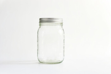Empty Glass Jar with Silver Lid on White Background