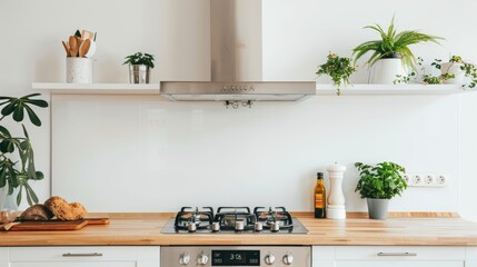 Modern kitchen with induction hob and extractor hood above wooden countertop