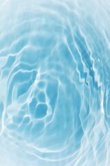 Blue water with ripples on the surface. Defocus blurred transparent blue colored clear calm water surface texture with splashes and bubbles. Water waves with shining pattern texture background.	