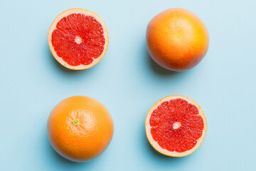 fresh Fruit grapefruit with Juicy grapefruit slices on colored background. Top view. Copy Space. creative summer concept. Half of citrus in minimal flat lay with copy space
