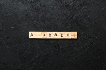 alphabet word written on wood block. alphabet text on cement table for your desing, concept
