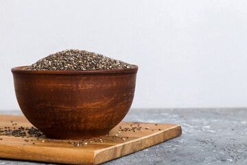 Chia seeds in bowl on colored background. Healthy Salvia hispanica in small bowl. Healthy superfood