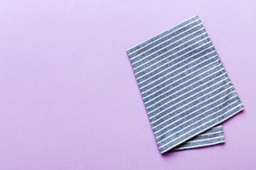 top view with blue kitchen napkin isolated on table background. Folded cloth for mockup with copy...