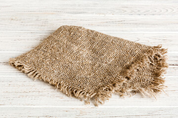 Old burlap fabric napkin, sackcloth on table background. top view with copy space
