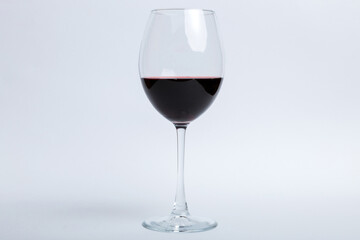 One glasses of red wine at wine tasting. Concept of red wine on colored background. Top view, flat lay design