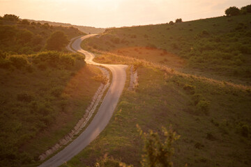 Long winding road in rural countryside leading off into distance.