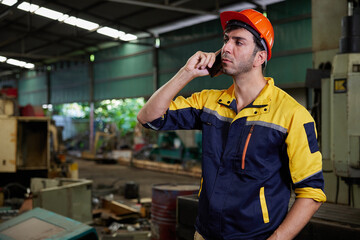 engineer or technician talking and calling on smartphone in the factory