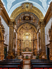 Fototapeta premium The intricate golden interior of the Carmelite church Igreja do Carmo in the old town of Faro in Portugal