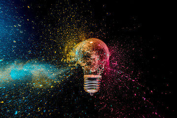 Lightbulb exploding with colorful powder