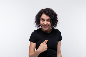 Cute brunette with curly hairstyle wearing a basic t-shirt