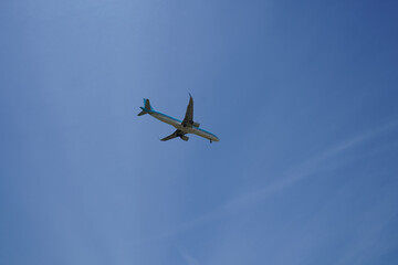 Airplane is flying in the sky with the landing gear down