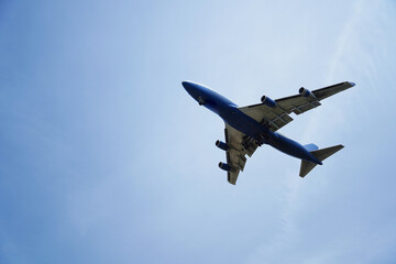 Airplane is flying in the sky with the landing gear down