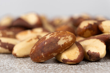 Macro brazil nuts on light grey background.