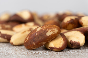 Macro brazil nuts on light grey background.