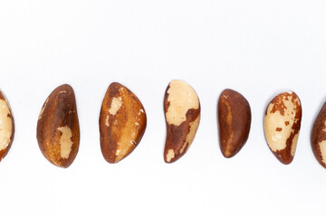 Close-up of Brazil nuts on white background top view.