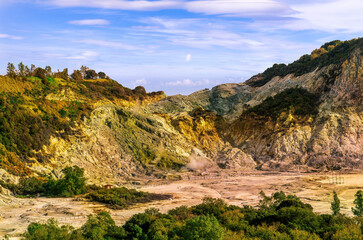 landscape of Plegrean volcano fields in Naples Italy near Pompeii with sulfur yellow caldera duribg eruption of smoke. campi Flegrei and cataclysm of Earthquake