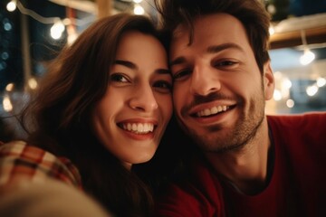 cheerful couple smiling at camera as if they are taking a selfie with smart phone