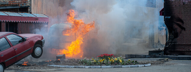 real explosion with fire and smoke on city street for banner background without people © serhii