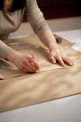 Obraz premium close up with kraft paper to draw future patterns for a dress