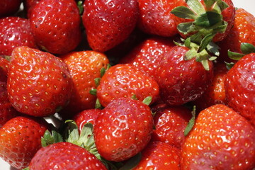 Texture. Beautiful background. Ripe washed strawberries under sunlight.