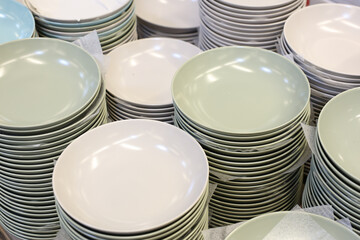 A stack of plates with a white plate in the middle