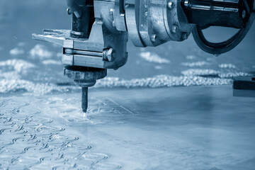 Close-up scene of multi-axis abrasive waterjet cutting machine cutting the aluminum plate.