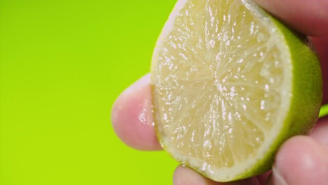 Squeezing out fresh Lime juice drains from the pulp Super slow-mo 1000 fps