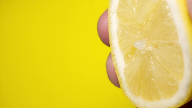 Squeezing out fresh Lemon juice drains from the pulp Super slow-mo 1000 fps