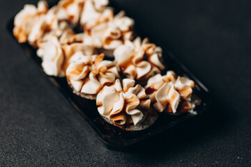 A delicious set of sushi with futo cream and eel on a black background