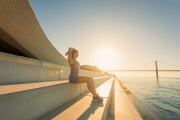 Runner outdoor. Fitness warm-up before running. Strong athletic woman running on natural...