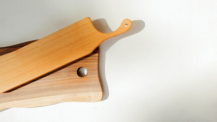 Kitchen background. Wooden kitchen utensils, boards. Kitchen utensils made of wood. Eco-friendly utensils. Top view, web banner
