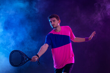 Padel Tennis Player with Racket in Hand. Paddle tenis, on a blue background. Download in high resolution.