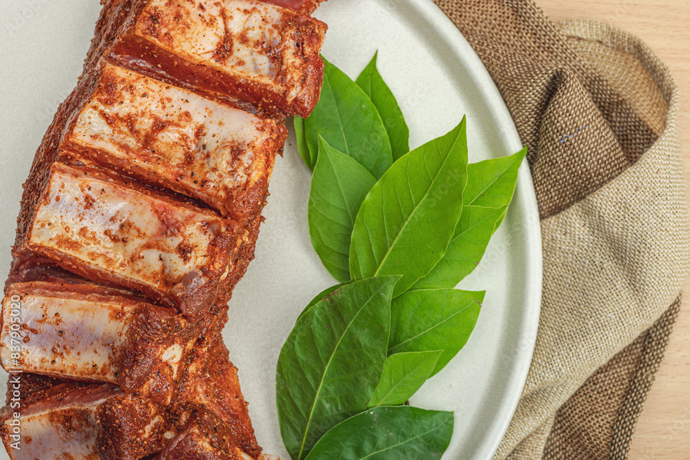 Wall mural marinated raw ribs with spices and herbs. traditional ingredient for bbq, picnic concept