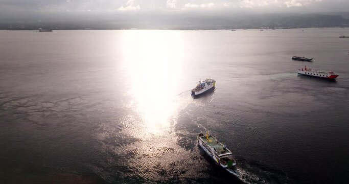 Ferry boats for transfers between Bali and Java, Gilimanuk port, Indonesia. Aerial drone view