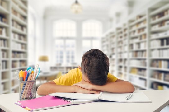 Sleeping, bored child student in the classroom