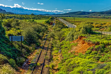 Landscape of Route 62 and old abandoned railway line with Swartberg mountain range in background...