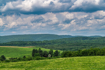 Landscape withe Hills, Trees and Clouds