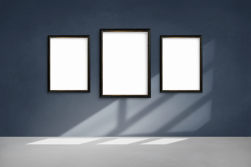 Black picture frame mockups hanging on  a blue wall