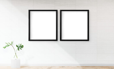Two blank black frames mockup on an off white wall