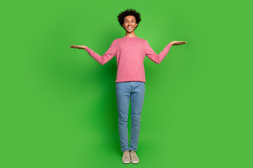 Full length photo of funky cool guy dressed pink pullover showing arms scales emtpy space isolated...