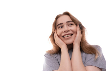 Fototapeta premium Kind modest bright blond teenager girl with braces in a gray T-shirt