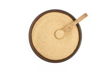 Amaranth grains in a plate and an old wooden spoon on it