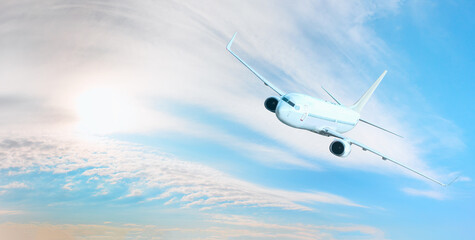 White passenger airplane flying in the sky amazing clouds in the background - Travel by air transport