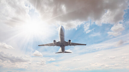 White passenger airplane flying in the sky amazing clouds in the background - Travel by air transport