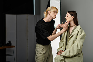 Man in black shirt stunningly applies makeup to womans face.