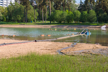 Pump and pipes for cleaning the bottom of the city pond